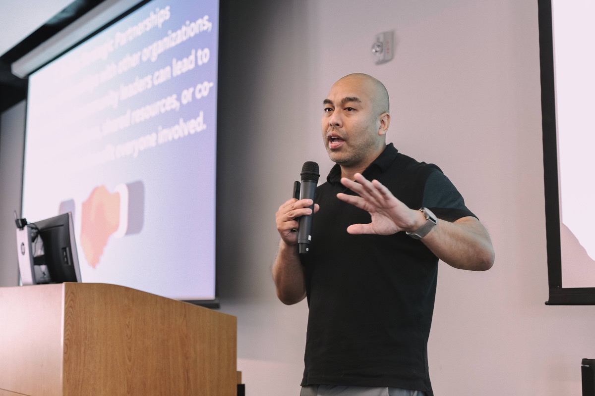 Jet Bunditwong speaking with a microphone during a presentation